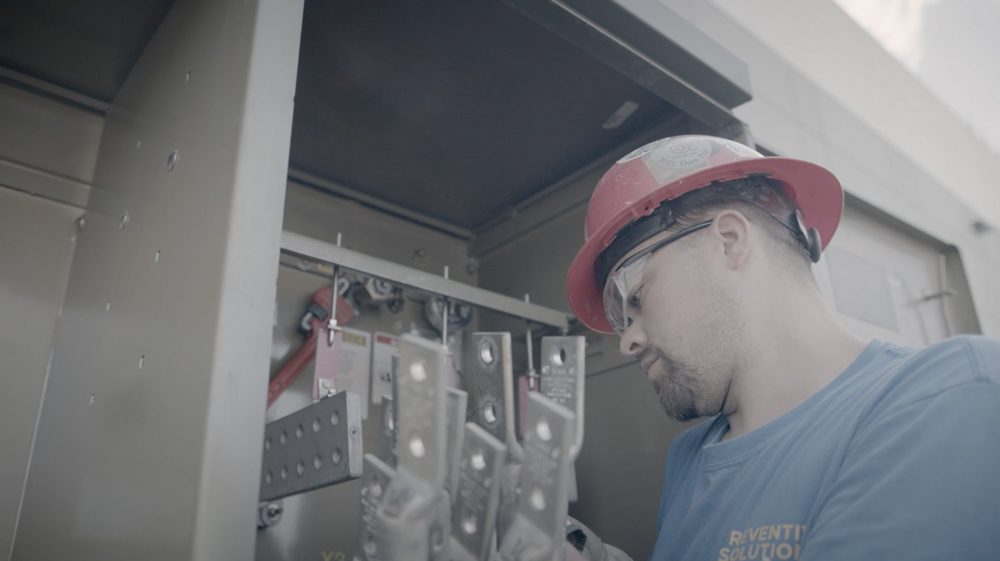 man checking components for de-energized standard maintenance